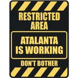   RESTRICTED AREA ATALANTA IS WORKING  PARKING SIGN