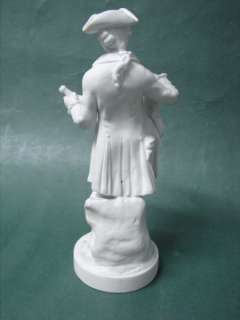   figurine of a violin musician with a wine bottle in the other