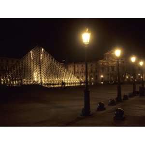 Pyramid Designed by Im Pei Lights up the Louvre Museum at Night, Paris 