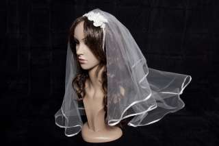 The veil edge is surrounded by white ribbon. It is mounted on a 