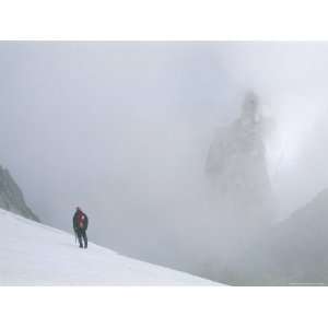 Mountain Climber Pauses on Vowell Glacier to Look at Howser Towers 