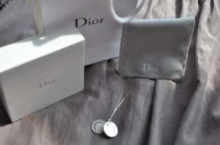   ring,rhodium plaed disc shooting star disc, and a silver Dior logo
