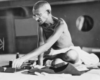 1931 photo Gandhi at his spinning wheel aboard shi  